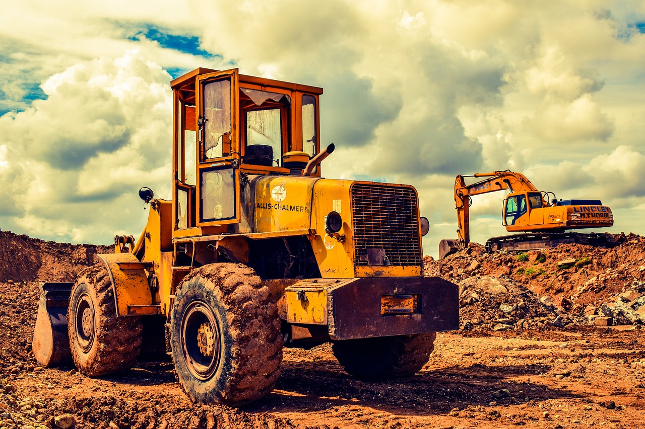 A bright yellow bulldozer positioned on a dirt field, ready for excavation and earth-moving tasks.