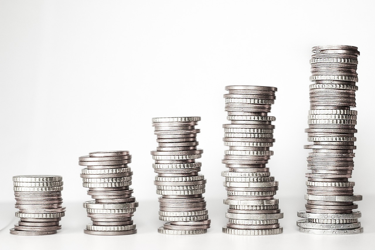 A close-up view of a stack of coins set against a white background, emphasising their details and arrangement.