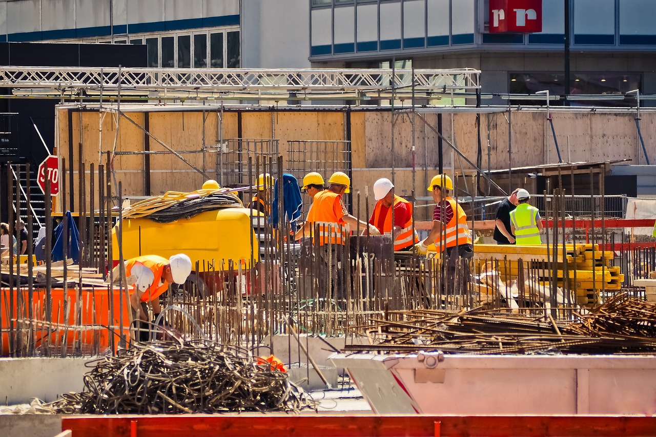 A group of construction workers engaged in various tasks at a construction site, highlighting their collaboration and effort.