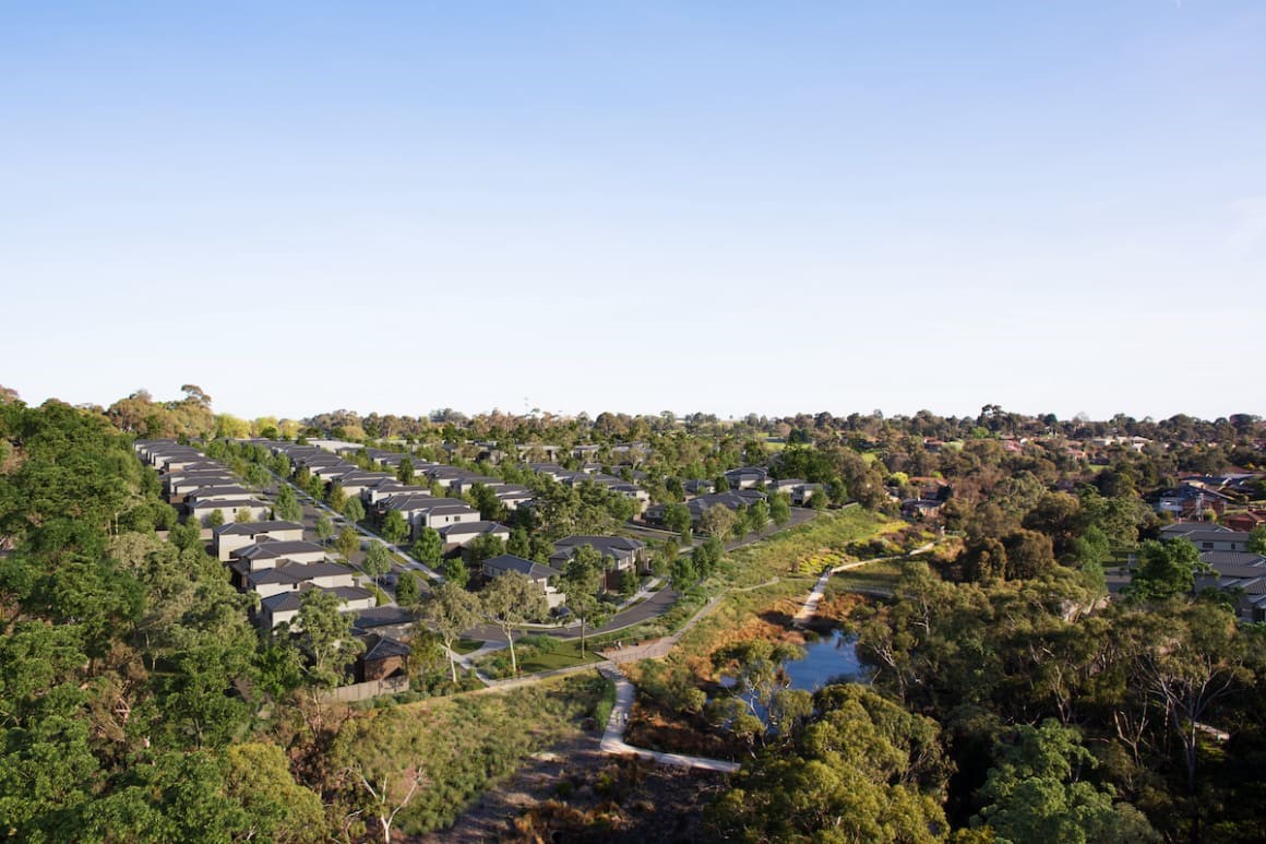 Aerial view of a serene forest neighbourhood, showcasing tree-lined streets and homes nestled among lush greenery for St Helena Place in St Helena, Victoria, Australia. 